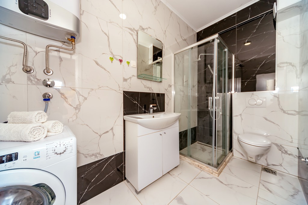 Apartment with sea views in residential building with an elevator in Rafailovici