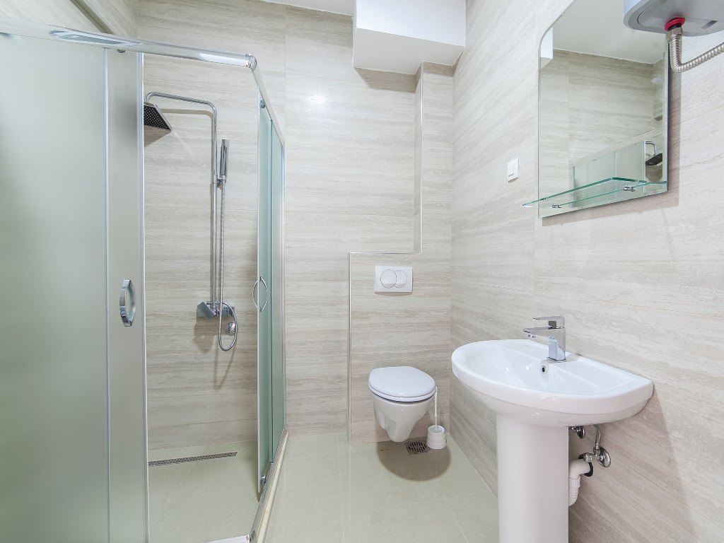 Apartment with sea views in residential building with an elevator in Rafailovici