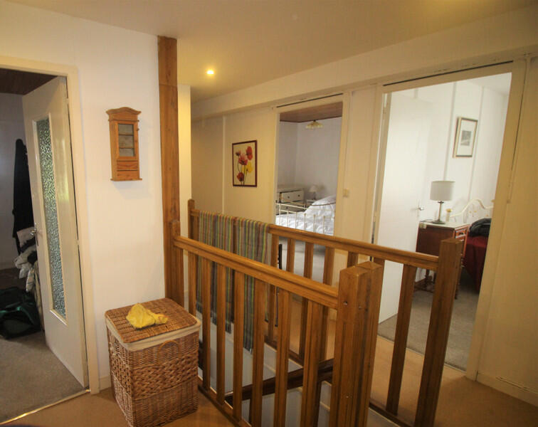 Nestled in a peaceful setting in the heart of a friendly rural area, this large property offers exceptional views of the surrounding countryside and remarkable development potential.