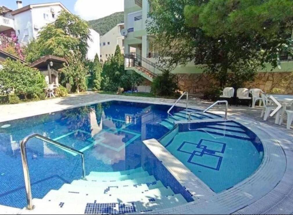 Stylish two-bedroom apartment for sale in a club house with a swimming pool and a real garden.