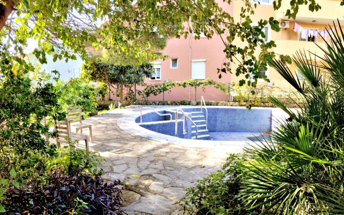 Stylish two-bedroom apartment for sale in a club house with a swimming pool and a real garden.
