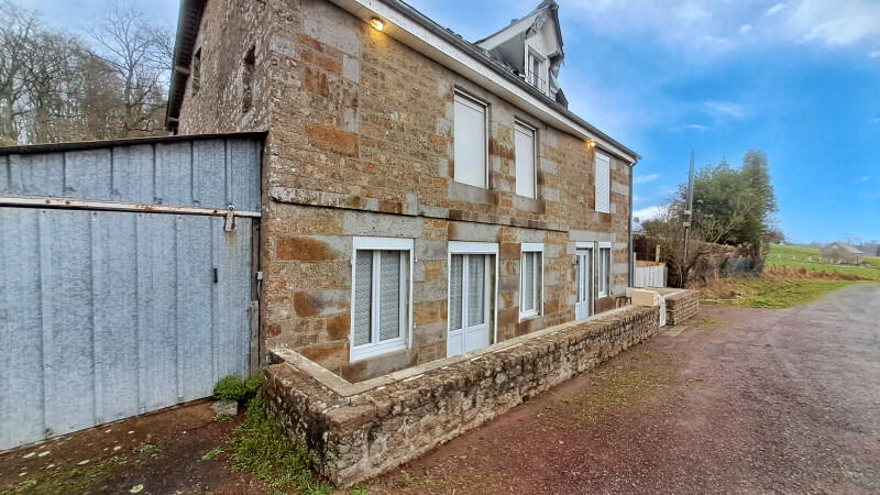 A spacious 4-bedroom stone house with garage and land, ideally located near Flers and Tinchebray-Bocage, offering easy access to all amenities